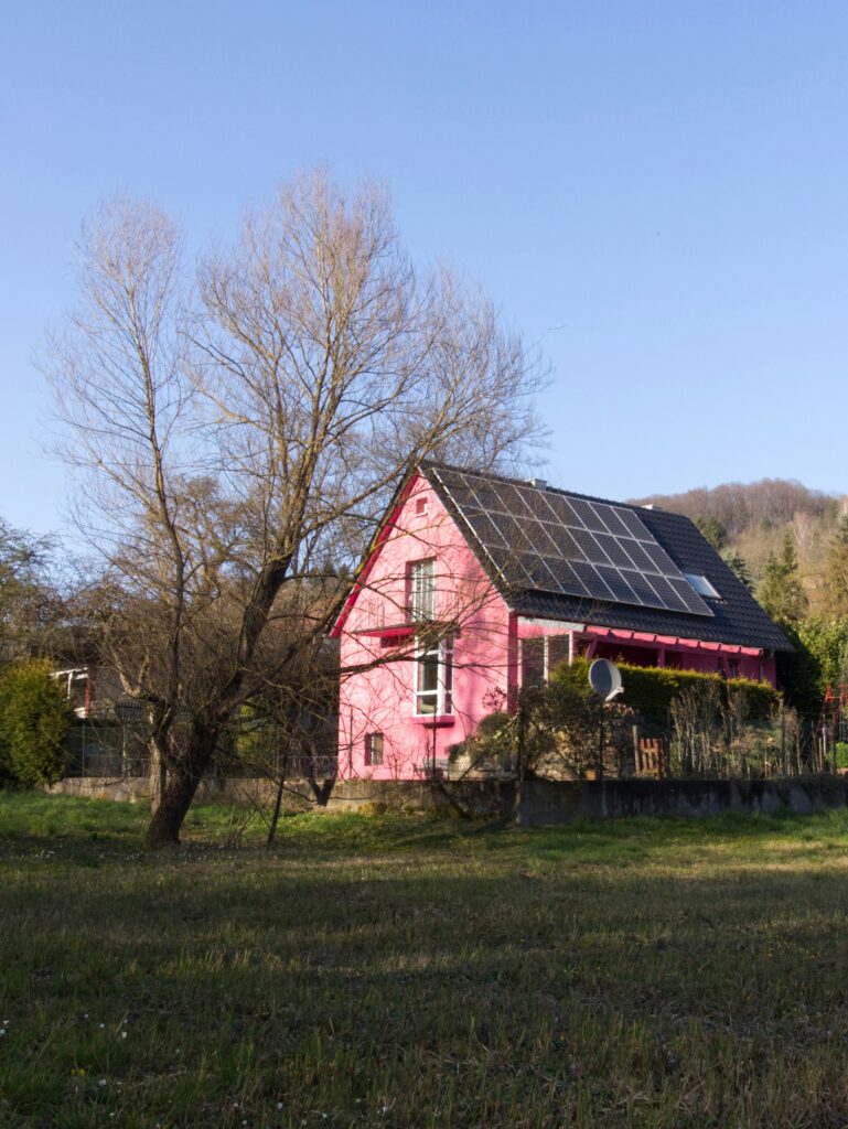 Red barn with solar panels on the roof representing renewable energy in Georgia