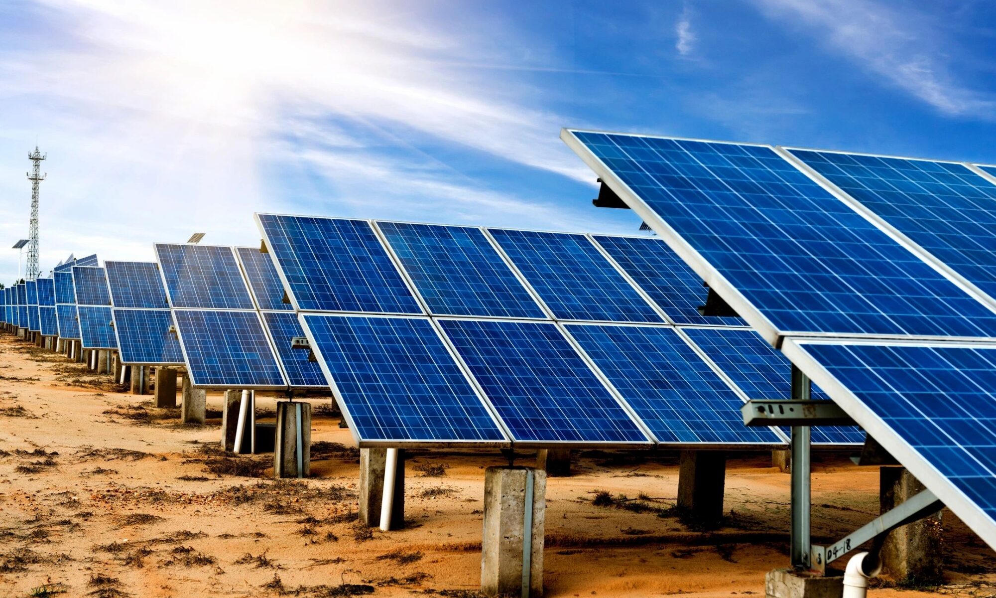 Solar panels on a field in bright sunlight representing renewable energy
