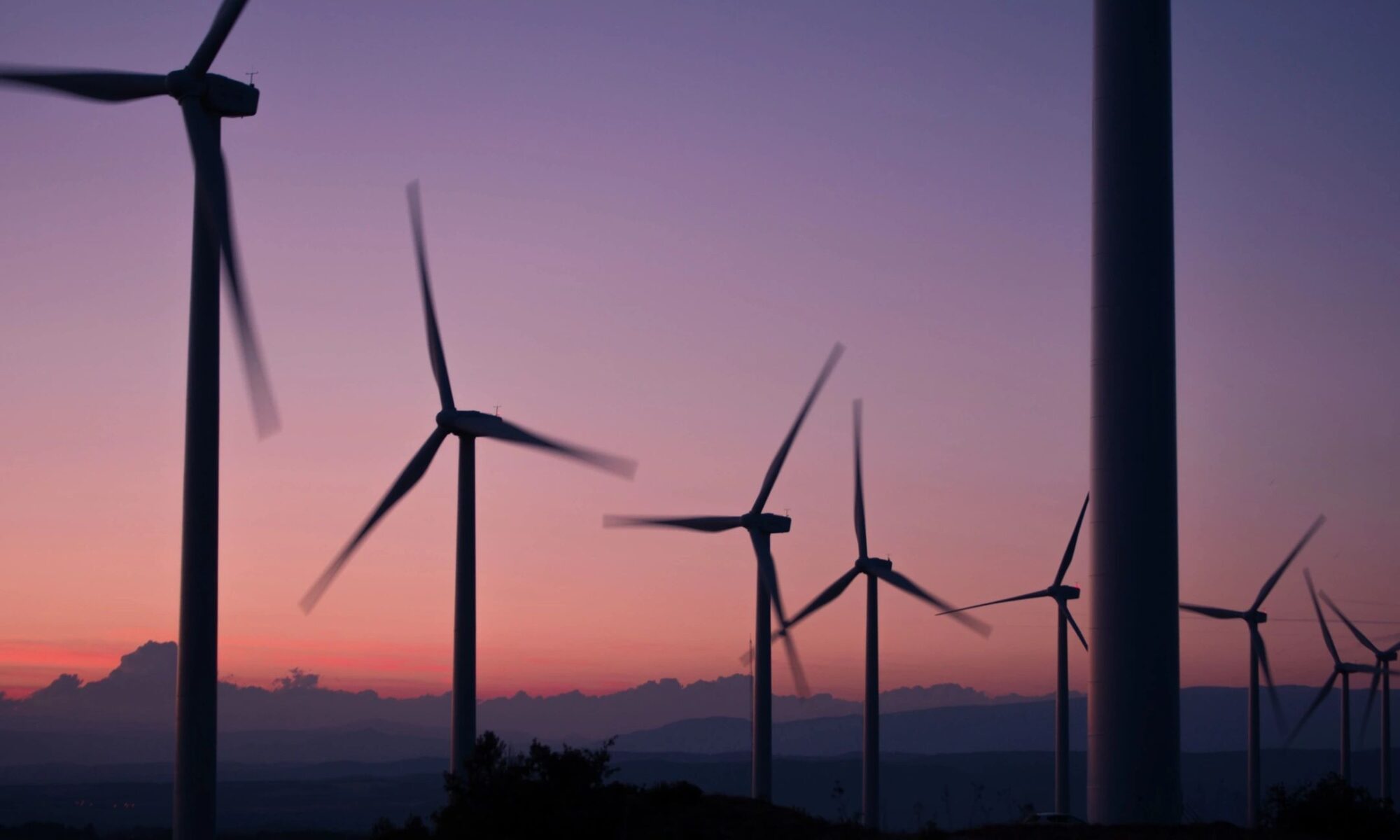 Wind turbines representing clean energy on the Alabama energy brokers and consultants page